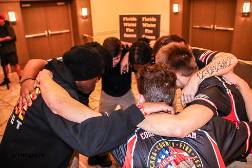 Image of cadets huddle together before competing