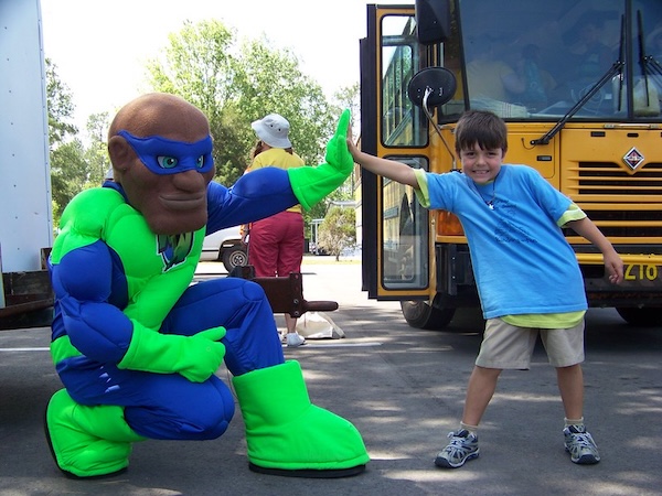 young child high-fiving a mascot