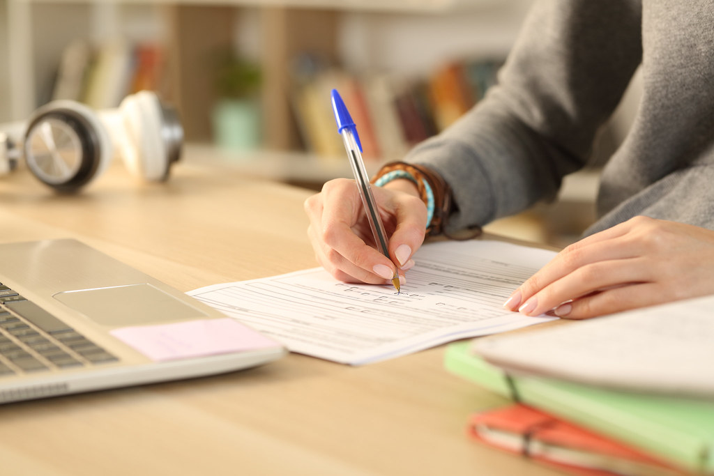 photo of a person filling out an application